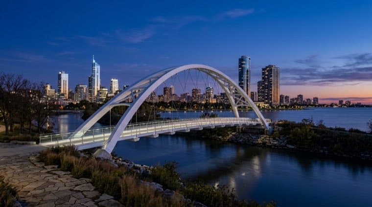 The Humber Bay Arch Bridge in Etobicoke with the Toronto skyline behind it.